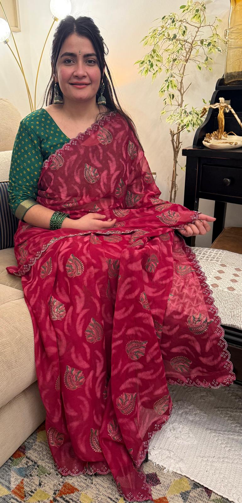 A beautiful cotton saree in a rich raspberry red hue,featuring delicate hand- painted motifs scattered gracefully across the fabric £30