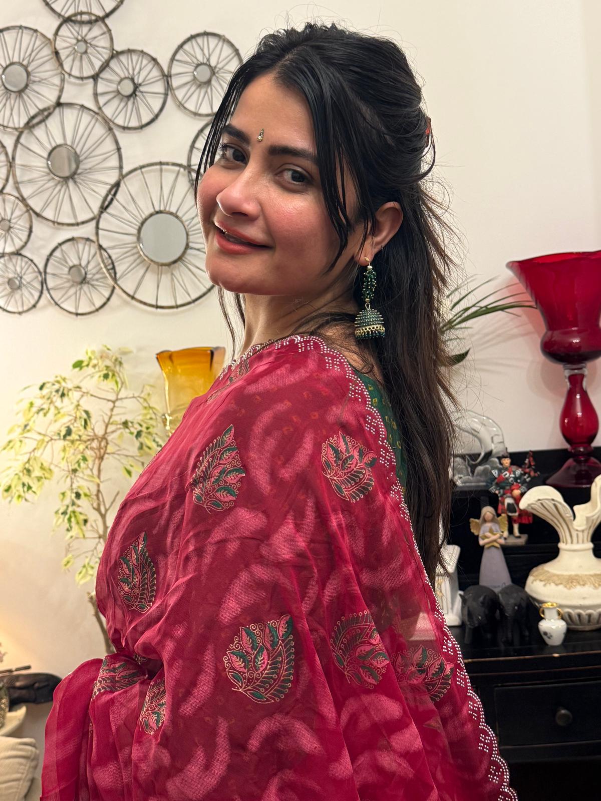 A beautiful cotton saree in a rich raspberry red hue,featuring delicate hand- painted motifs scattered gracefully across the fabric £30