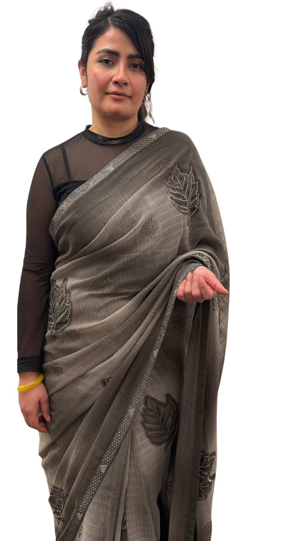 A mud grey chiffon saree adorned with delicate stone work,intricately arranged in graceful leafy ,motifs,lending it a refined and sophisticated charm.£55