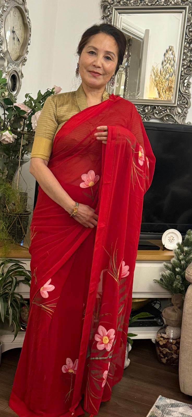 Scarlet red hand painted saree, adorned with delicate floral artwork with smooth satin border,this saree feels light,fluid and effortlessly elegant £45