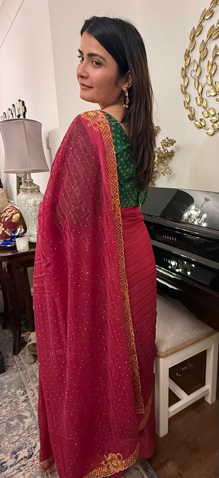 Ruby red chiffon saree with delicate gold stonework.Effortlessly elegant and exquisitely beautiful.It celebrates the devine  grace and timeless beauty of womanhood £60