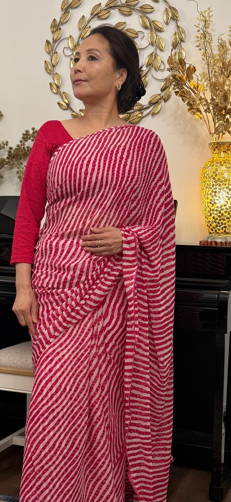 A feather light hot pink chiffon, adorned with elegant oblique lines, exuding effortless grace and contemporary charm  £30