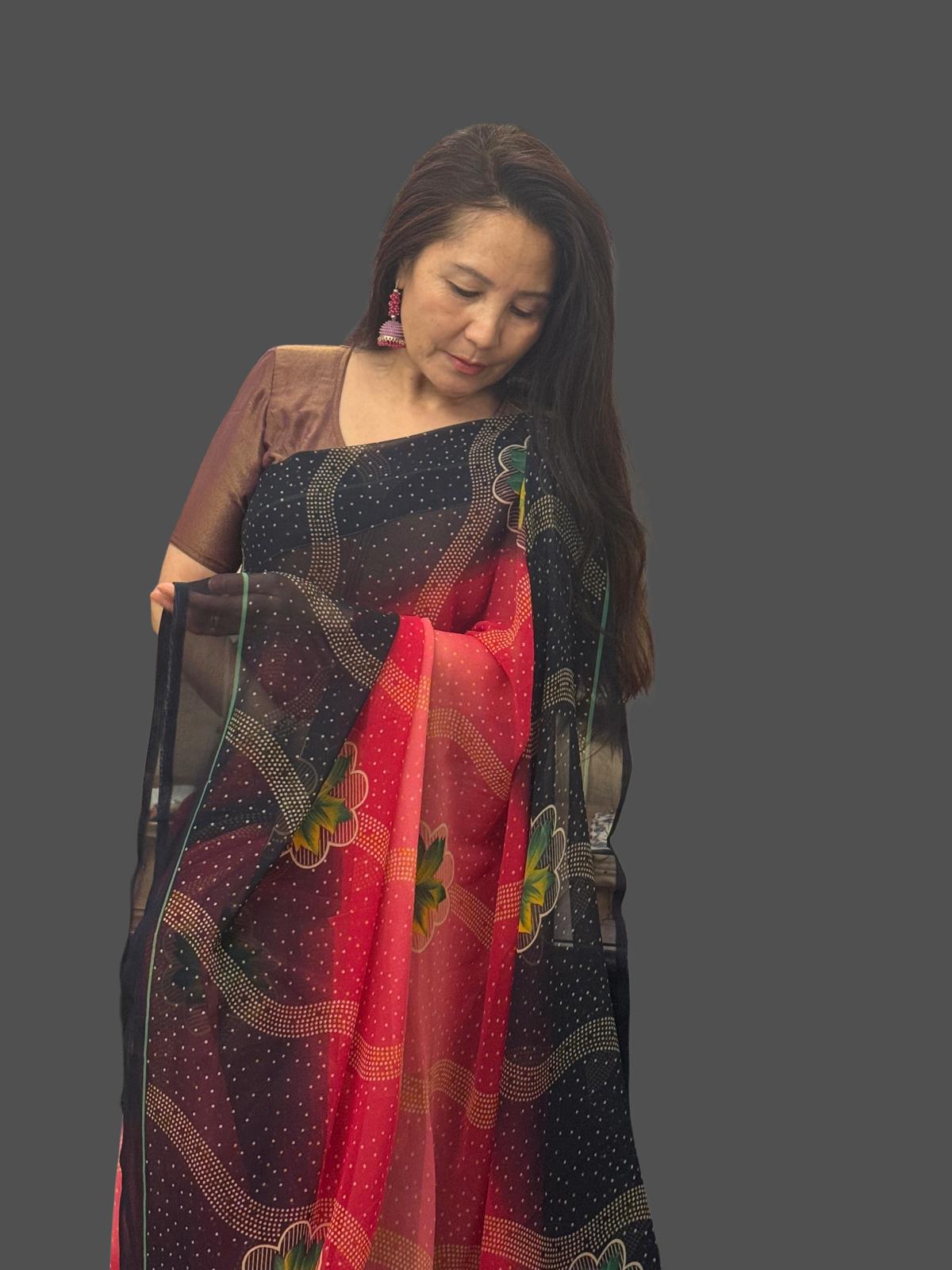 A beautiful shaded red saree with soft pink undertones featuring a navy blue border adorned with subtle diagonal lines and delicate floral prints.Light weight and effortlessly graceful,it offers both comfort and striking visual appeal £35
