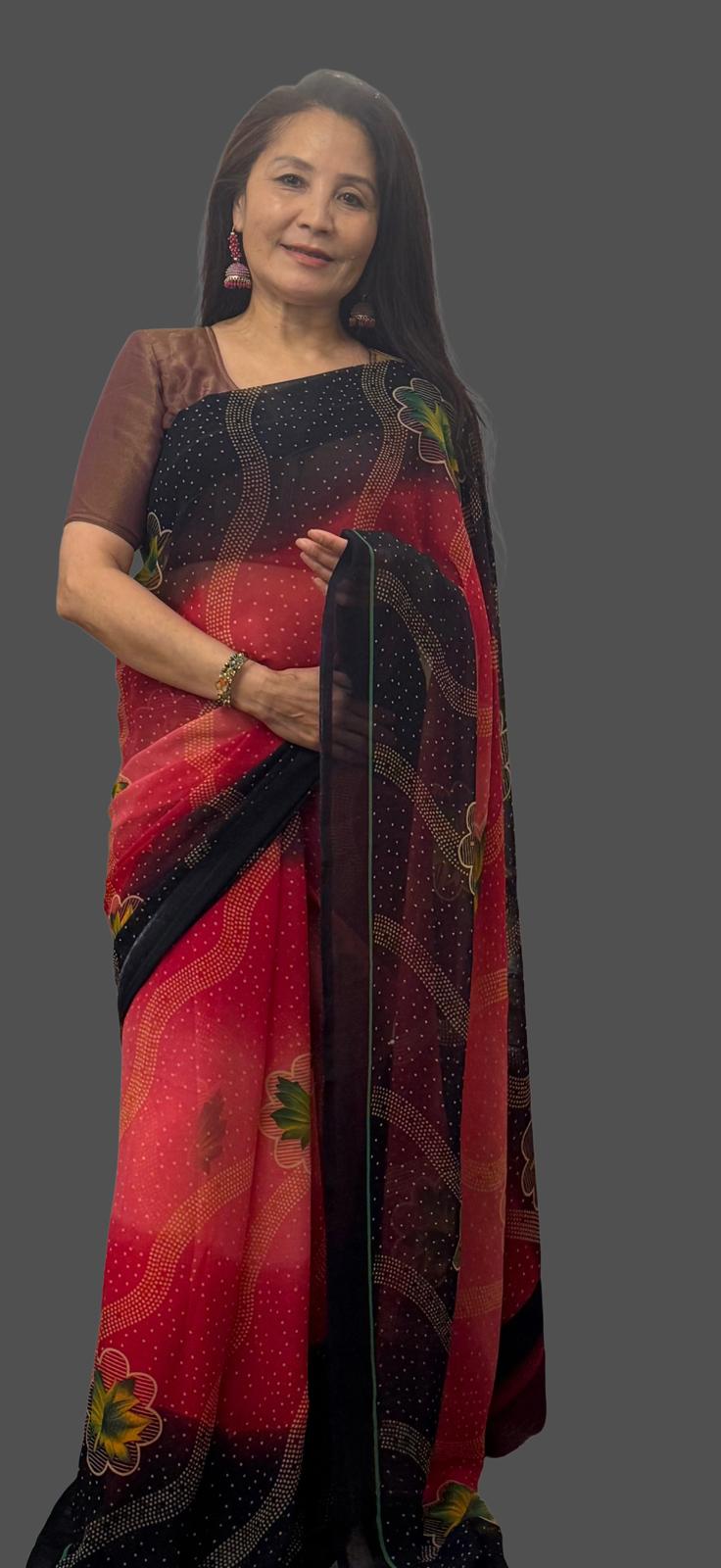 A beautiful shaded red saree with soft pink undertones featuring a navy blue border adorned with subtle diagonal lines and delicate floral prints.Light weight and effortlessly graceful,it offers both comfort and striking visual appeal £35