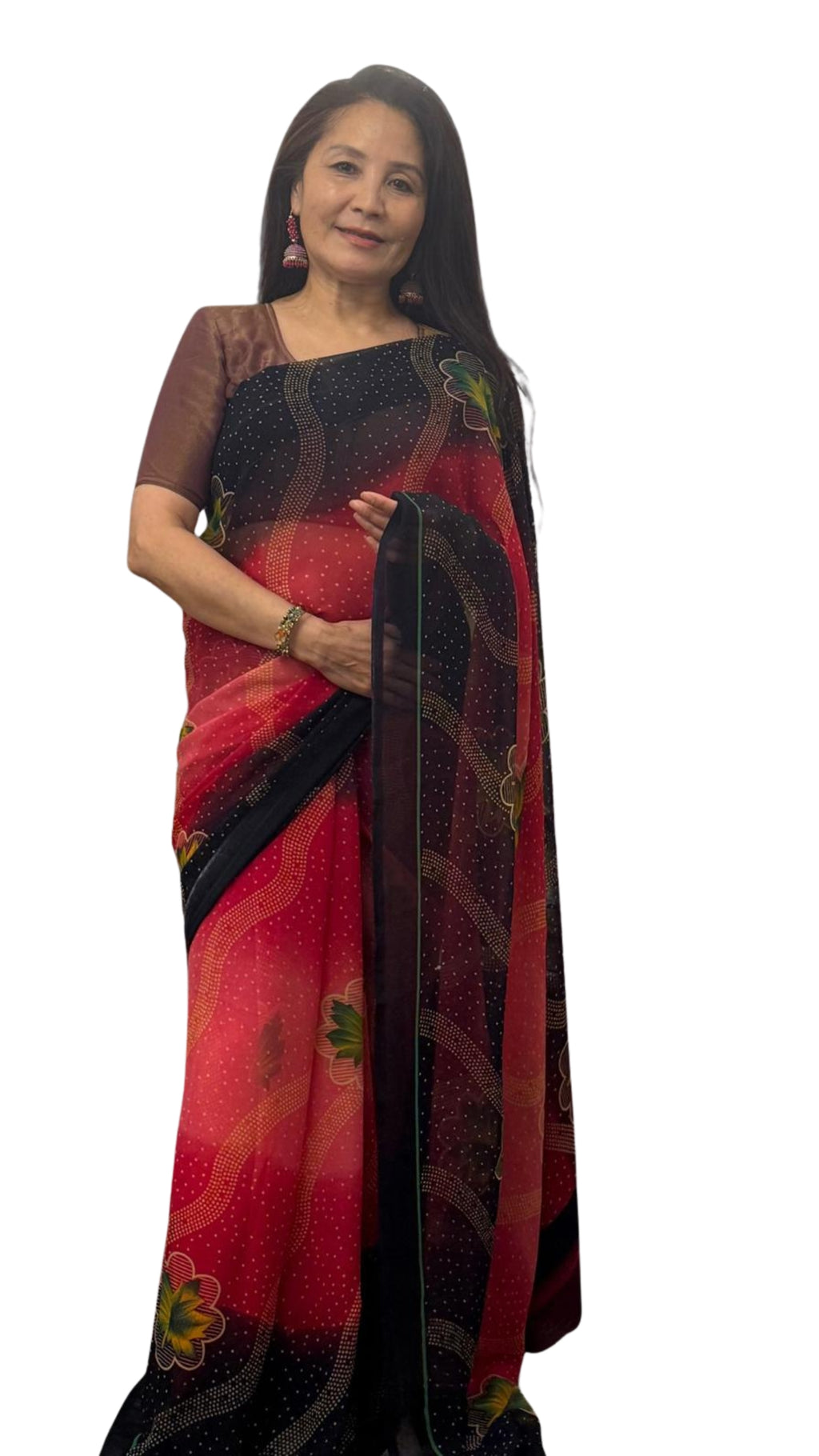 A beautiful shaded red saree with soft pink undertones featuring a navy blue border adorned with subtle diagonal lines and delicate floral prints.Light weight and effortlessly graceful,it offers both comfort and striking visual appeal £35