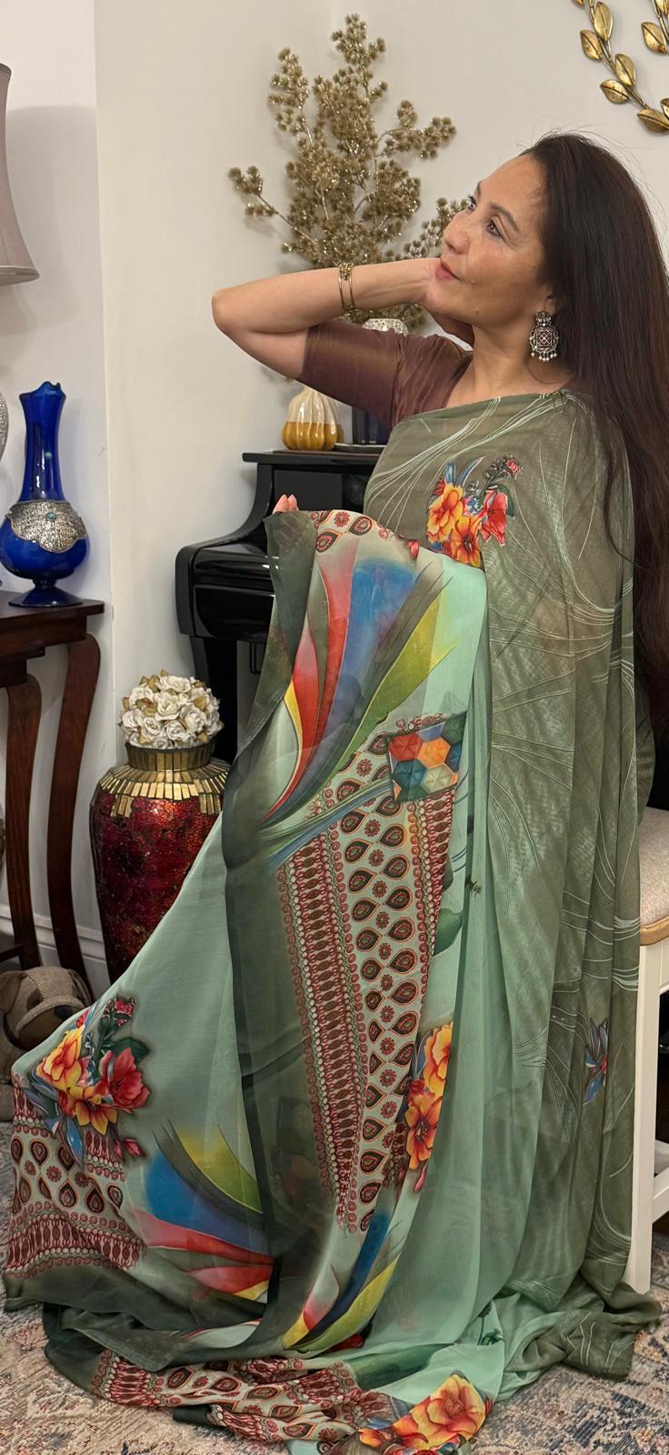 A celadon green lightweight saree, beautifully adorned with elegant digital prints, offering a modern and smart appeal £35