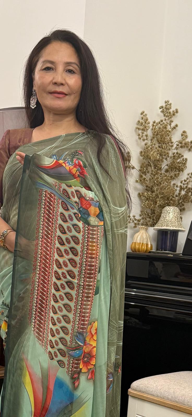 A celadon green lightweight saree, beautifully adorned with elegant digital prints, offering a modern and smart appeal £35