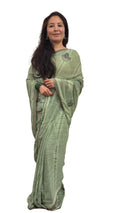 A celadon green lightweight saree, beautifully adorned with elegant digital prints, offering a modern and smart appeal £35