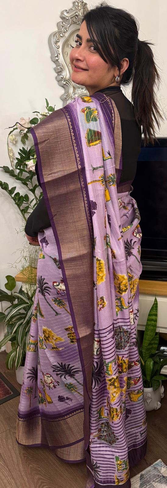 A lavender silk saree with a rich plum border delicately detailed with subtle zari work throughout. Showcasing ethnic, folk- inspired drawings that reflects culture and place with timeless pride. £80 tbc