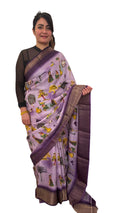 A lavender silk saree with a rich plum border delicately detailed with subtle zari work throughout. Showcasing ethnic, folk- inspired drawings that reflects culture and place with timeless pride. £80 tbc