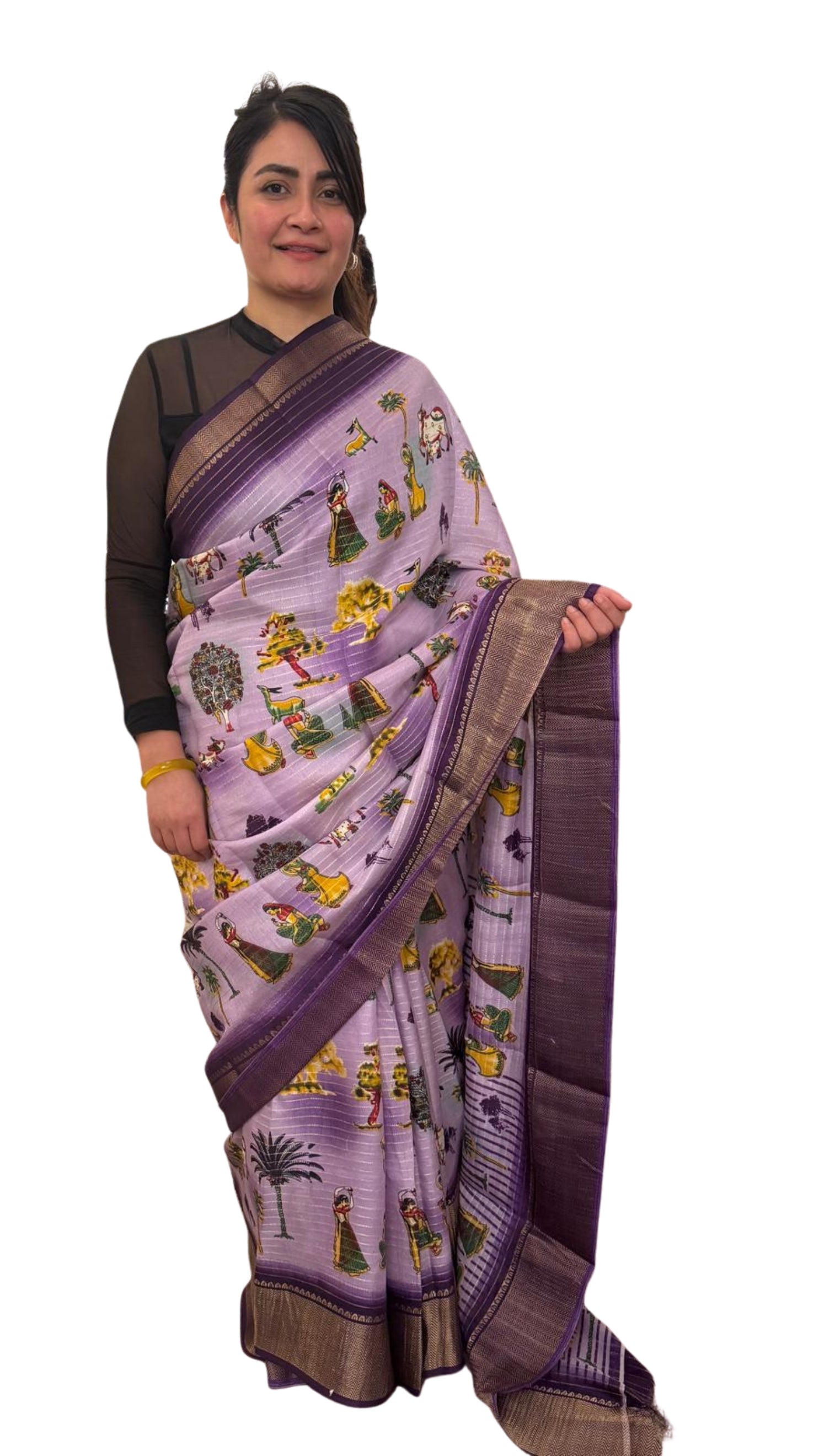 A lavender silk saree with a rich plum border delicately detailed with subtle zari work throughout. Showcasing ethnic, folk- inspired drawings that reflects culture and place with timeless pride. £80 tbc