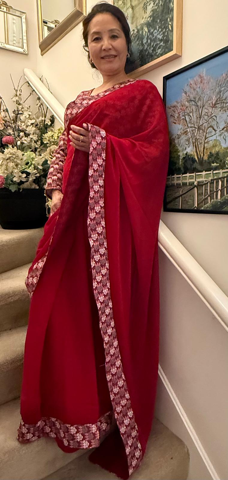 Lipstick red plain Dhaka print saree, beautifully embellished with authentic Nepali Dhaka print work along the border,enhancing its charm and grace. £135