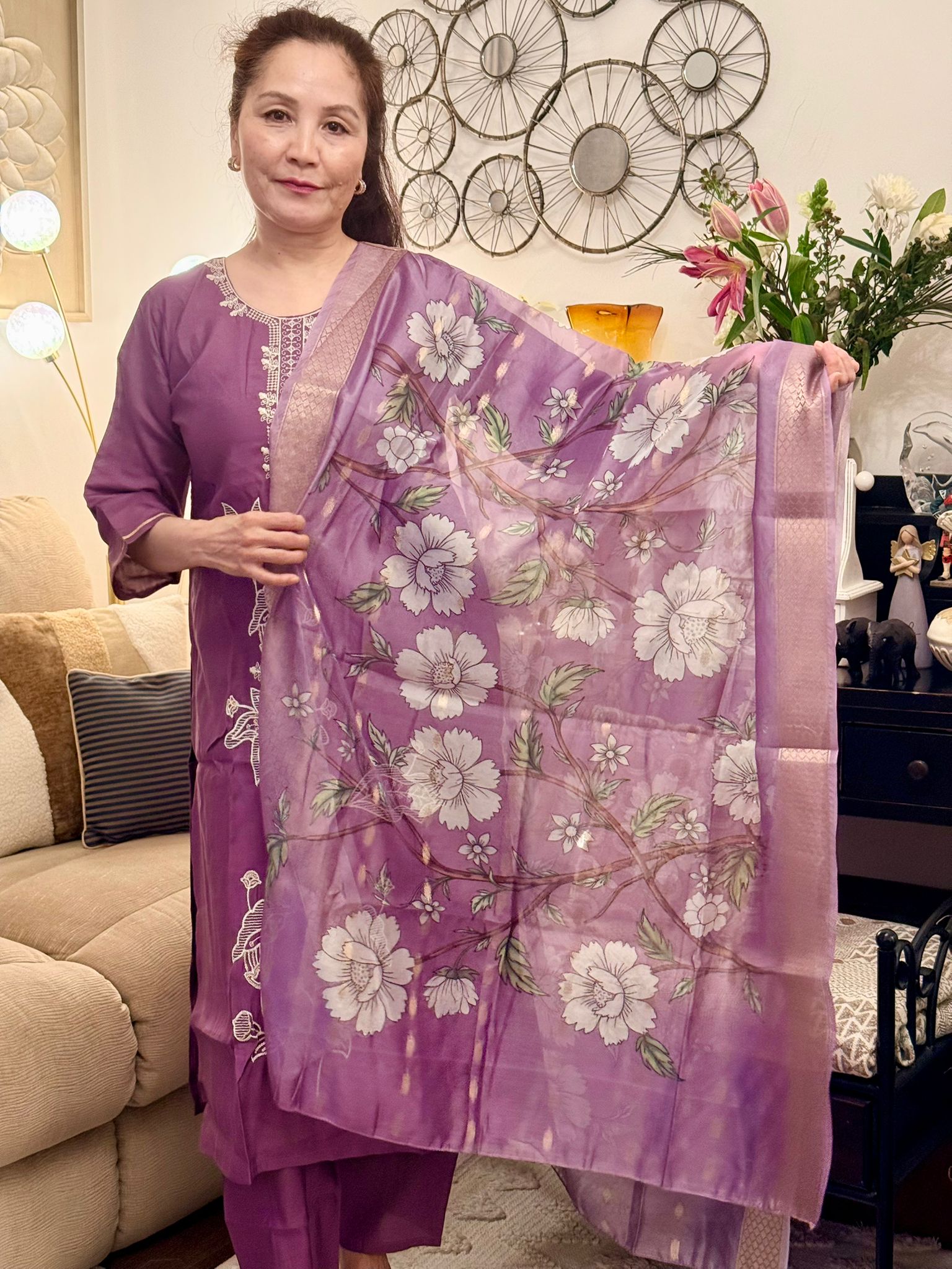 Delicate white thread embroidery set against a soft mauve backdrop creates a timeless and graceful appeal. £30