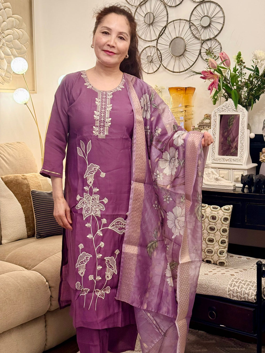 Delicate white thread embroidery set against a soft mauve backdrop creates a timeless and graceful appeal. £30
