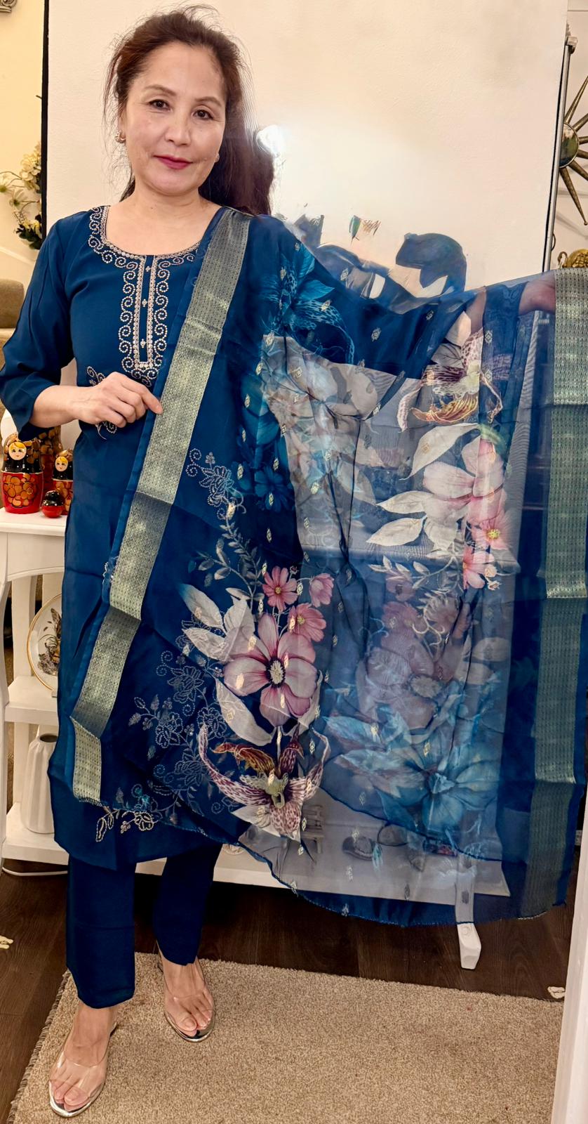 A striking Dodgers blue suit, beautifully adorned with delicate gold detailing that adds a touch of understated luxury.Paired with a coordinating floral print shawl. £30