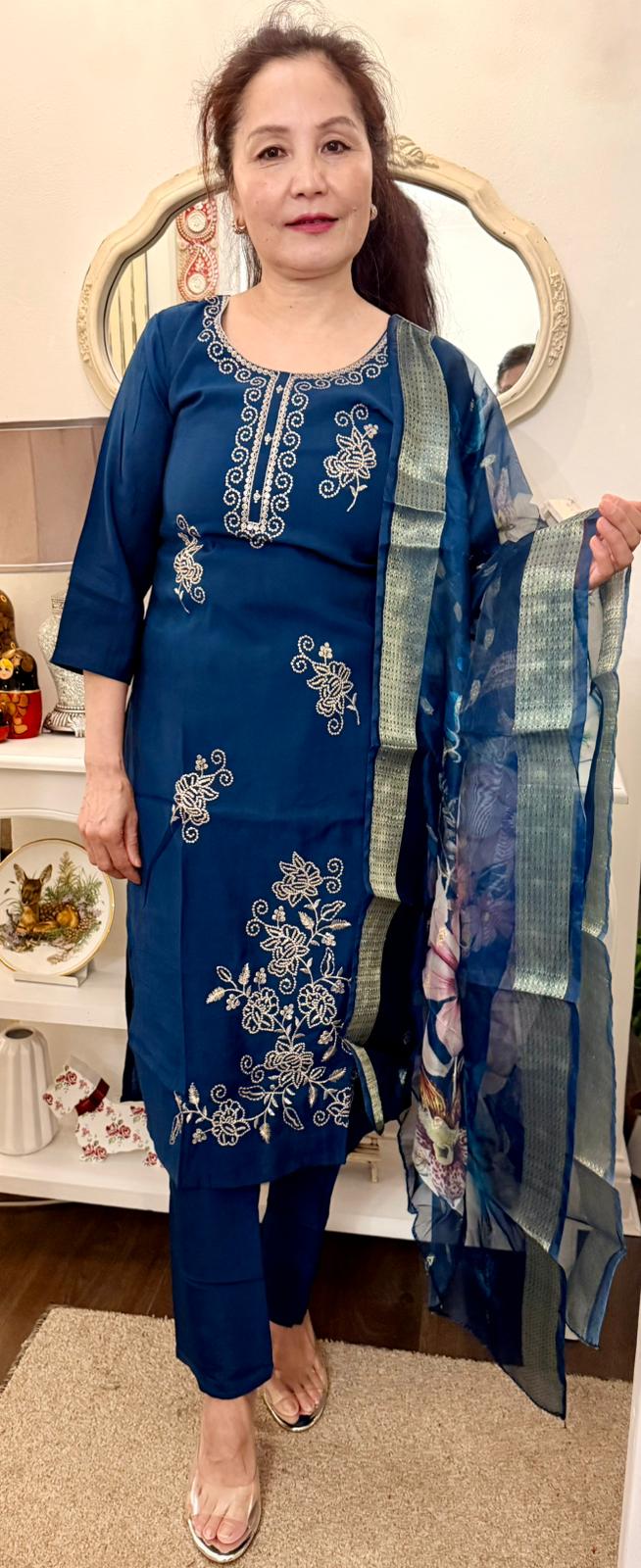 A striking Dodgers blue suit, beautifully adorned with delicate gold detailing that adds a touch of understated luxury.Paired with a coordinating floral print shawl. £30