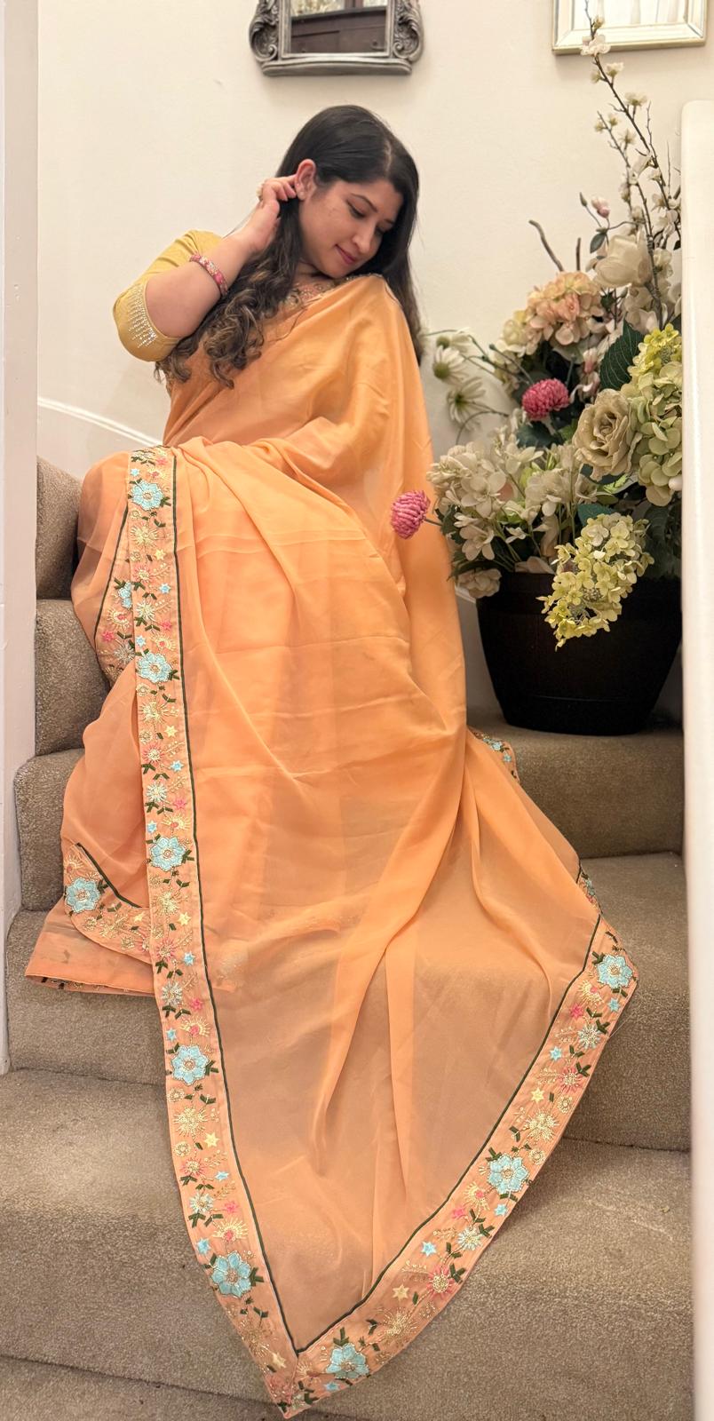 Peach satin ciffon, with embroidered border £55