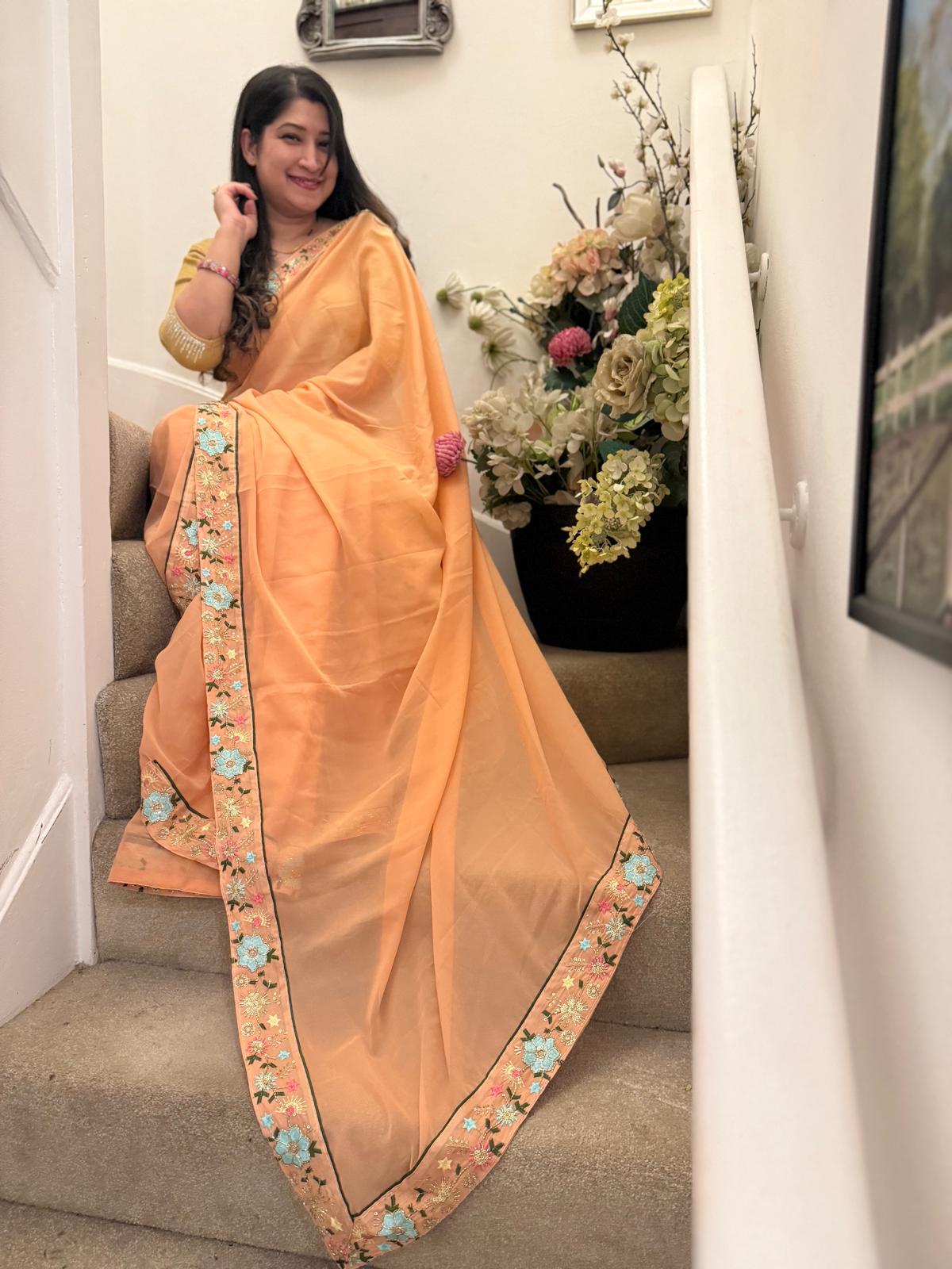 Peach satin ciffon, with embroidered border £55