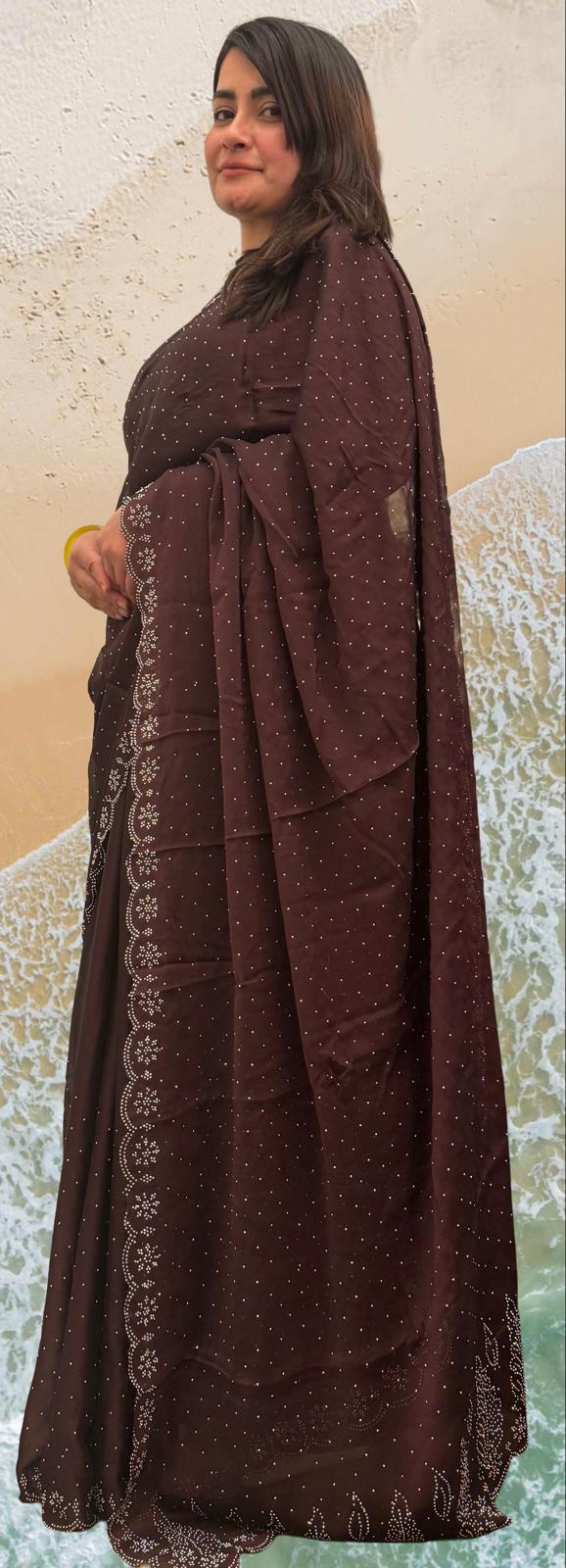 A graceful garnet coloured saree, beautifully adorned with delicate stone work that adds a subtle sparkle £55